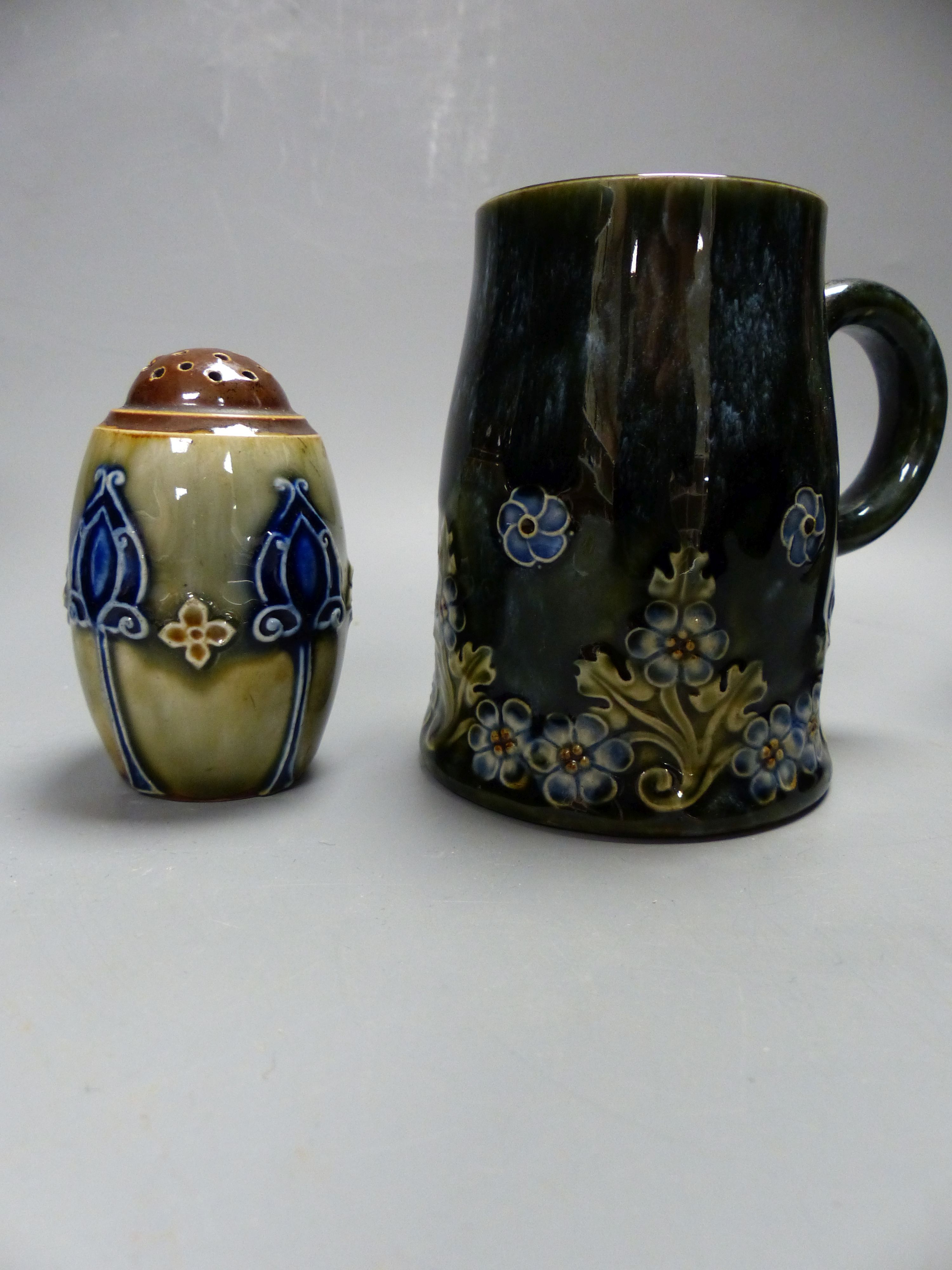 Four pieces of Royal Doulton stoneware including two vases, a mug and a pepperette, tallest 16cm